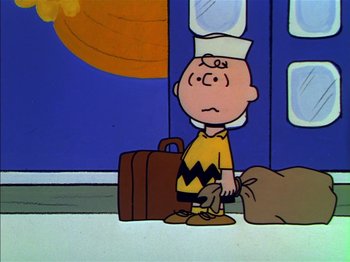 Movie still from “A Boy Named Charlie Brown” (1969), directed by Bill Melendez – A charlie brown character standing in front of a building; Wide shot, High angle