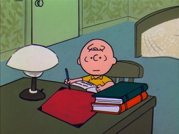 Movie still from “A Boy Named Charlie Brown” (1969), directed by Bill Melendez – Charlie brown sitting at a desk writing on a piece of paper; Medium shot, High angle