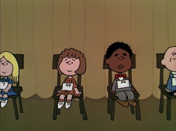 Movie still from “A Boy Named Charlie Brown” (1969), directed by Bill Melendez – A couple of kids are sitting in a chair; Wide shot, High angle