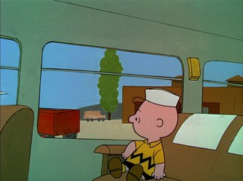 Movie still from “A Boy Named Charlie Brown” (1969), directed by Bill Melendez – A charlie brown character sitting on a bus; Wide shot, High angle