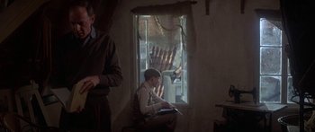 Movie still from “A Bridge Too Far” (1977), directed by Richard Attenborough – A man and a boy sitting in front of a window; Medium shot, Low angle