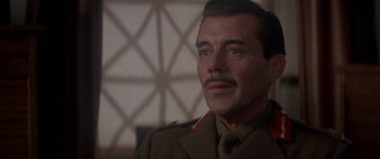 Movie still from “A Bridge Too Far” (1977), directed by Richard Attenborough – A person wearing a uniform; Close Up shot, Low angle