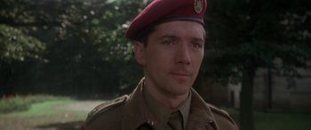 Movie still from “A Bridge Too Far” (1977), directed by Richard Attenborough – A man in a military uniform wearing a red hat; Close Up shot, Low angle