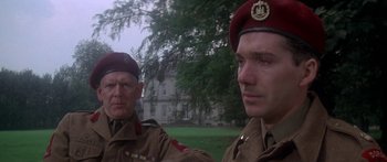 Movie still from “A Bridge Too Far” (1977), directed by Richard Attenborough – Two men in military uniforms standing next to each other; Close Up shot, Low angle
