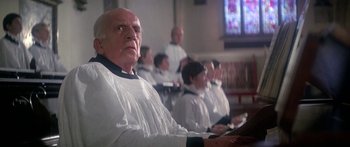 Movie still from “A Bridge Too Far” (1977), directed by Richard Attenborough – A group of people sitting in front of each other; Close Up shot, Low angle