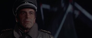 Movie still from “A Bridge Too Far” (1977), directed by Richard Attenborough – A person wearing a military uniform; Close Up shot, Low angle