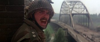 Movie still from “A Bridge Too Far” (1977), directed by Richard Attenborough – A man with a helmet on and a military uniform on; Close Up shot, Low angle