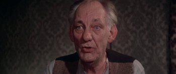 Movie still from “A Bridge Too Far” (1977), directed by Richard Attenborough – An old man with a gray beard is looking at the camera; Close Up shot, High angle