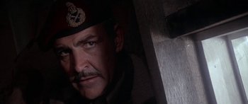 Movie still from “A Bridge Too Far” (1977), directed by Richard Attenborough – A person wearing a uniform; Close Up shot, Low angle