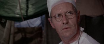 Movie still from “A Bridge Too Far” (1977), directed by Richard Attenborough – An older man wearing glasses and a chef's hat; Close Up shot, Low angle
