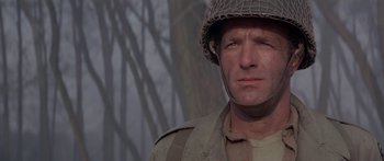 Movie still from “A Bridge Too Far” (1977), directed by Richard Attenborough – A man in a military uniform wearing a helmet; Close Up shot, Low angle