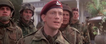 Movie still from “A Bridge Too Far” (1977), directed by Richard Attenborough – A group of men standing next to each other wearing military uniforms; Close Up shot, Low angle