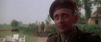 Movie still from “A Bridge Too Far” (1977), directed by Richard Attenborough – A man in a military uniform looking to his left; Close Up shot, Low angle