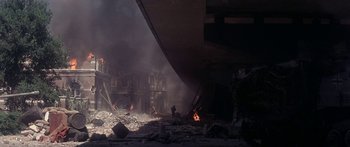 Movie still from “A Bridge Too Far” (1977), directed by Richard Attenborough – A building that has been destroyed by a fire; Extreme Wide shot, High angle