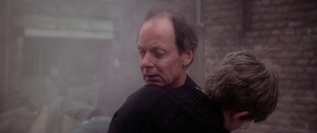 Movie still from “A Bridge Too Far” (1977), directed by Richard Attenborough – An older man is holding his head in his hands; Close Up shot, Over the shoulder angle