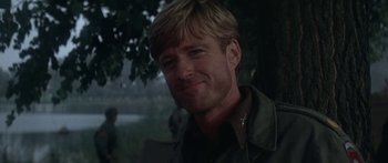 Movie still from “A Bridge Too Far” (1977), directed by Richard Attenborough – A person smiling for a picture; Close Up shot, Over the shoulder angle