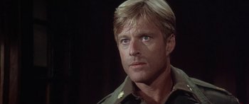 Movie still from “A Bridge Too Far” (1977), directed by Richard Attenborough – A person wearing a military uniform; Close Up shot, Low angle