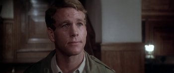 Movie still from “A Bridge Too Far” (1977), directed by Richard Attenborough – A person wearing a jacket; Close Up shot, Over the shoulder angle