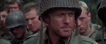 Movie still from “A Bridge Too Far” (1977), directed by Richard Attenborough – A person wearing a helmet; Close Up shot, Over the shoulder angle