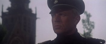 Movie still from “A Bridge Too Far” (1977), directed by Richard Attenborough – A person wearing a uniform; Close Up shot, Low angle