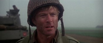 Movie still from “A Bridge Too Far” (1977), directed by Richard Attenborough – A person wearing a helmet; Close Up shot, Over the shoulder angle