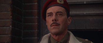 Movie still from “A Bridge Too Far” (1977), directed by Richard Attenborough – A person wearing a hat; Close Up shot, Low angle