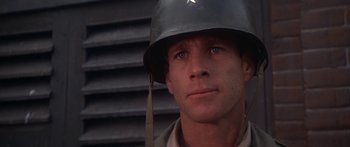 Movie still from “A Bridge Too Far” (1977), directed by Richard Attenborough – A man wearing a military helmet with a star on it; Close Up shot, Low angle