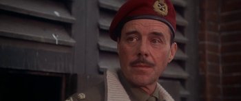 Movie still from “A Bridge Too Far” (1977), directed by Richard Attenborough – A person wearing a hat; Close Up shot, Low angle