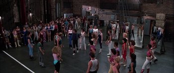 Movie still from “A Chorus Line” (1985), directed by Richard Attenborough – A large group of people are gathered together in a gym; Wide shot, High angle