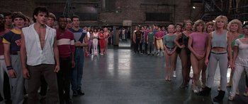 Movie still from “A Chorus Line” (1985), directed by Richard Attenborough – A large group of people standing in a room; Wide shot, High angle