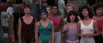 Movie still from “A Chorus Line” (1985), directed by Richard Attenborough – A group of women standing next to each other in a room; Medium shot, High angle