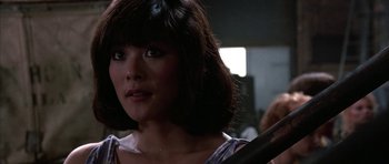 Movie still from “A Chorus Line” (1985), directed by Richard Attenborough – A person holding a baseball bat; Close Up shot, Over the shoulder angle