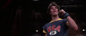 Movie still from “A Chorus Line” (1985), directed by Richard Attenborough – A man in a blue shirt and a red headband; Close Up shot, Low angle