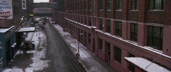 Movie still from “A Chorus Line” (1985), directed by Richard Attenborough – A city street with snow on the ground and buildings; Extreme Wide shot, High angle
