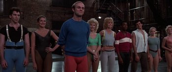 Movie still from “A Chorus Line” (1985), directed by Richard Attenborough – A group of people standing next to each other; Medium shot, Low angle