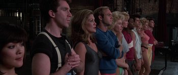 Movie still from “A Chorus Line” (1985), directed by Richard Attenborough – A group of people standing in a line; Medium shot, Low angle