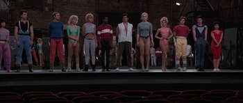 Movie still from “A Chorus Line” (1985), directed by Richard Attenborough – A group of men and women standing on a stage; Wide shot, Low angle