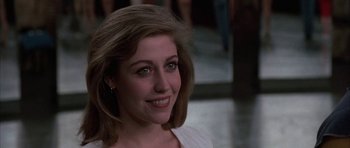 Movie still from “A Chorus Line” (1985), directed by Richard Attenborough – A person smiling; Close Up shot, Over the shoulder angle