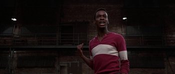 Movie still from “A Chorus Line” (1985), directed by Richard Attenborough – A man in a red and white striped shirt; Medium shot, Low angle