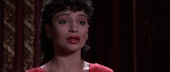 Movie still from “A Chorus Line” (1985), directed by Richard Attenborough – A person wearing a red shirt; Close Up shot, High angle