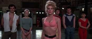 Movie still from “A Chorus Line” (1985), directed by Richard Attenborough – A group of people standing in a room; Medium shot, Low angle