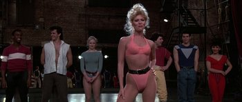 Movie still from “A Chorus Line” (1985), directed by Richard Attenborough – A group of women standing next to each other in bikinis; Medium shot, Low angle