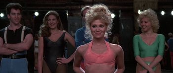 Movie still from “A Chorus Line” (1985), directed by Richard Attenborough – A group of women standing next to each other in a room; Medium shot, Over the shoulder angle