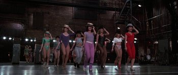 Movie still from “A Chorus Line” (1985), directed by Richard Attenborough – A group of women are dancing on a stage; Wide shot, High angle