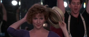 Movie still from “A Chorus Line” (1985), directed by Richard Attenborough – A person wearing a hat; Close Up shot, Over the shoulder angle