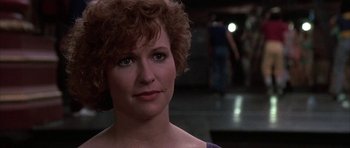 Movie still from “A Chorus Line” (1985), directed by Richard Attenborough – A person wearing a purple shirt; Close Up shot, Over the shoulder angle