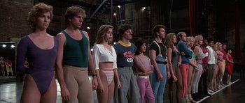 Movie still from “A Chorus Line” (1985), directed by Richard Attenborough – A group of people standing next to each other; Medium shot, Low angle