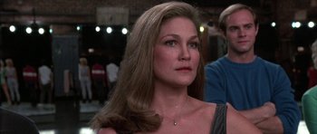 Movie still from “A Chorus Line” (1985), directed by Richard Attenborough – A person with long brown hair; Close Up shot, Over the shoulder angle