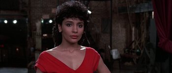 Movie still from “A Chorus Line” (1985), directed by Richard Attenborough – A person wearing a red dress; Close Up shot, Low angle