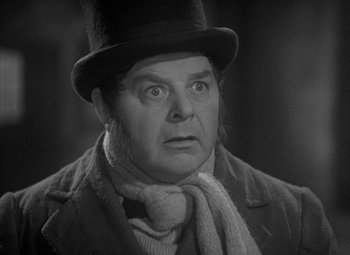 Movie still from “A Christmas Carol” (1938), directed by Edwin L. Marin – An older man wearing a top hat and a scarf; Close Up shot, Over the shoulder angle